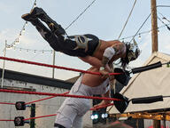 fight long_hair mask overalls pose:elbow_lever pose:leaning_back shirtless sport squared_circle subject:human type:photograph wrestler wrestling // 2667x2000 // 588KB